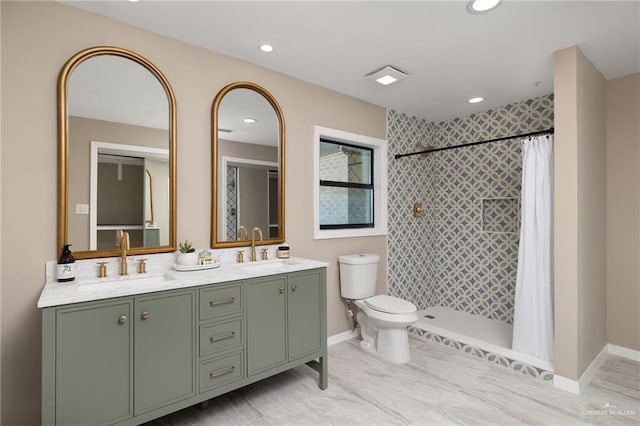 bathroom featuring vanity, curtained shower, and toilet