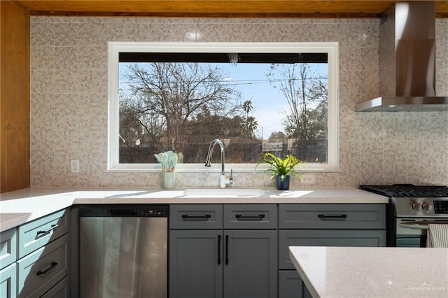 kitchen featuring appliances with stainless steel finishes, sink, wall chimney range hood, and plenty of natural light