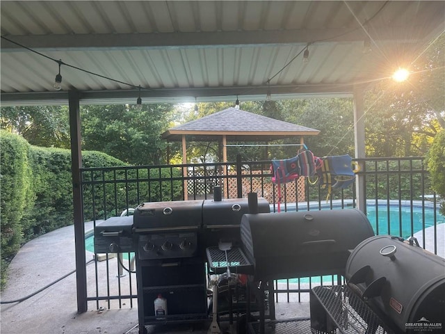 view of patio featuring a fenced in pool, a grill, and a gazebo