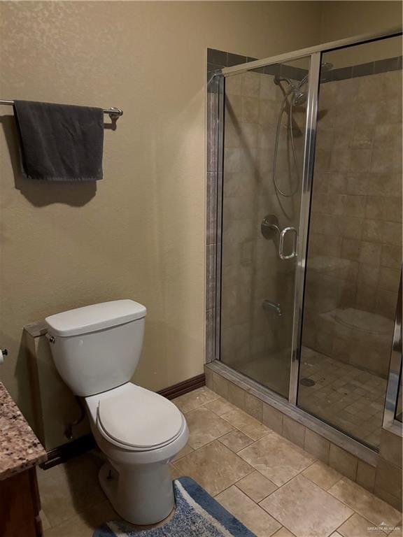 bathroom with vanity, an enclosed shower, and toilet