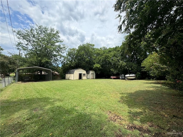 view of yard with a storage unit and a carport