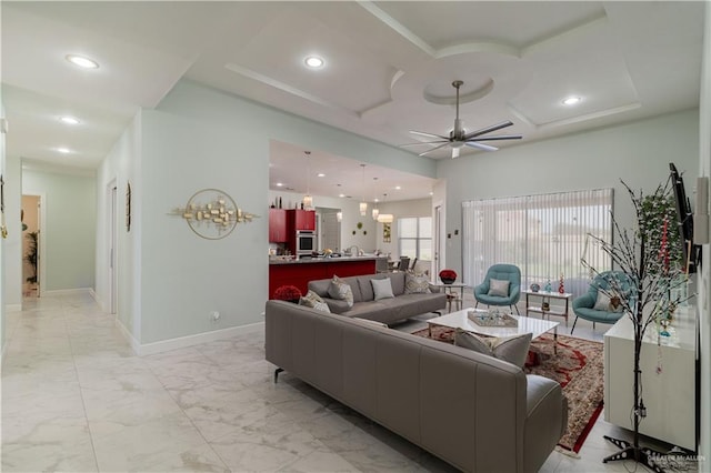 living room featuring ceiling fan and coffered ceiling