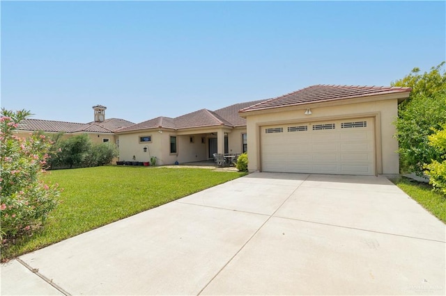 view of front of house with a garage and a front lawn