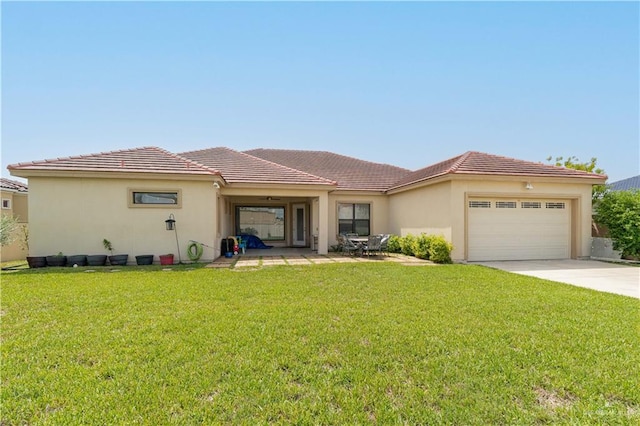 view of front of property with a front yard and a garage