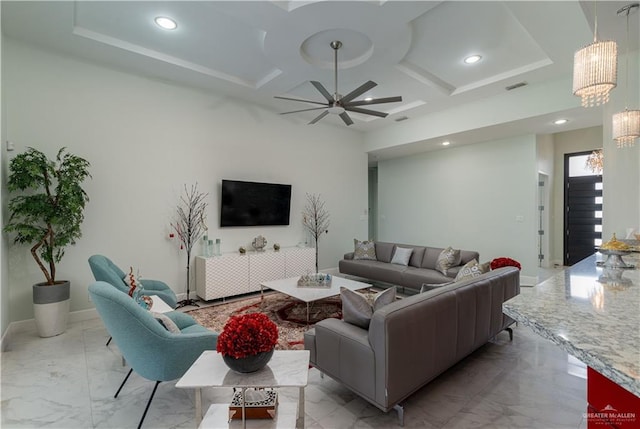 living room featuring ceiling fan with notable chandelier and coffered ceiling