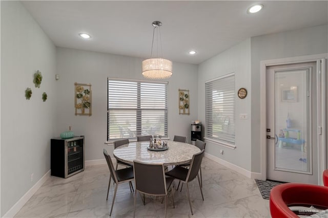 dining area featuring wine cooler and plenty of natural light