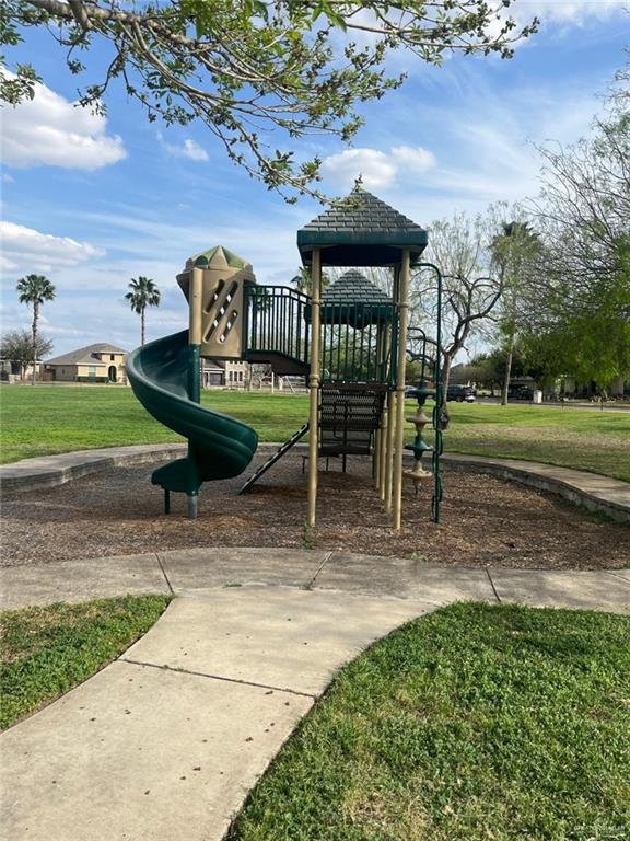 community jungle gym with a yard