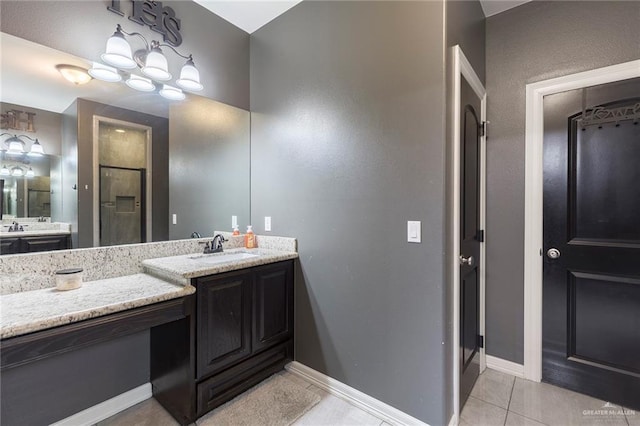 bathroom featuring two vanities, a stall shower, tile patterned flooring, and a sink