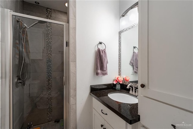 bathroom with a shower stall and vanity