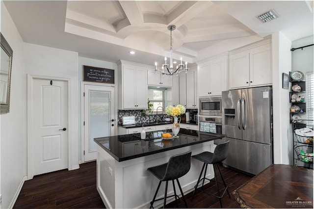 kitchen featuring stainless steel appliances, visible vents, white cabinets, backsplash, and dark wood finished floors