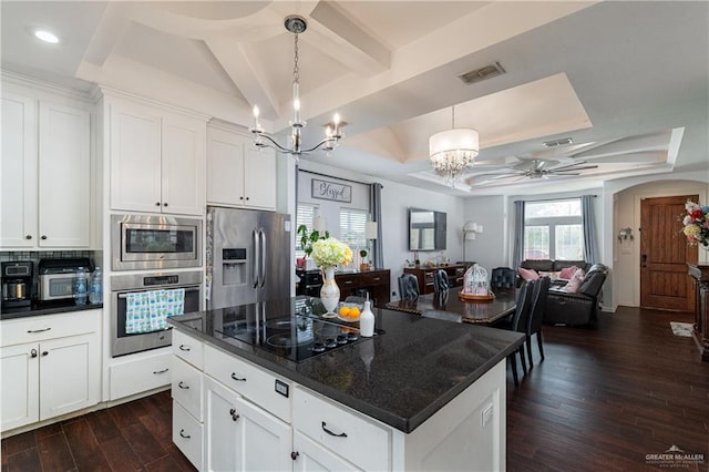 kitchen featuring stainless steel appliances, dark wood-type flooring, visible vents, white cabinets, and decorative backsplash