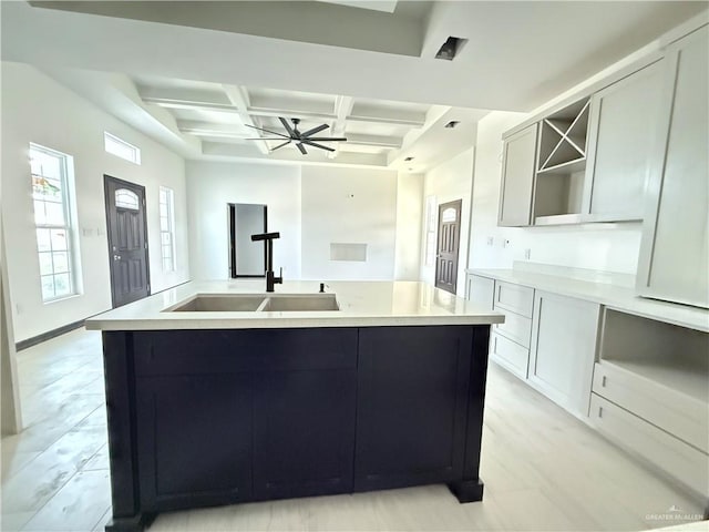 204 S 83rd St, Edinburg, TX 78542 - kitchen featuring coffered ceiling, a sink, beamed ceiling, an island with sink, and light countertops