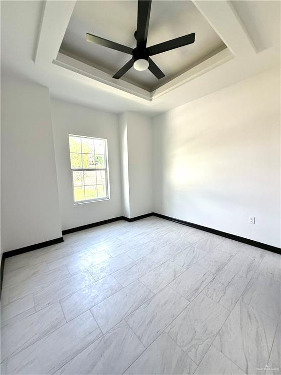 204 S 83rd St, Edinburg, TX 78542 - empty room featuring a raised ceiling, a ceiling fan, and baseboards