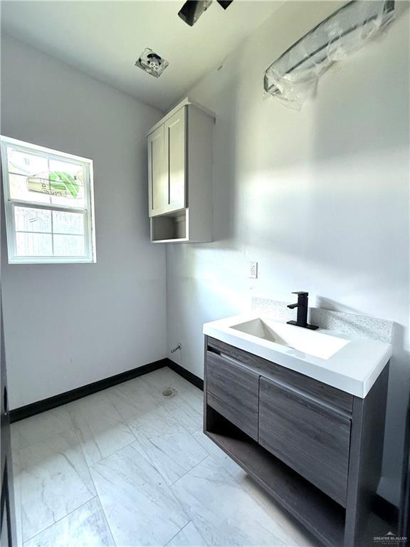 204 S 83rd St, Edinburg, TX 78542 - bathroom with marble finish flooring, vanity, and baseboards