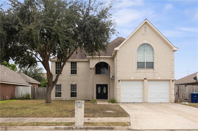 2401 Wisteria Ave, Mcallen, TX 78504 - traditional home with driveway, an attached garage, and brick siding