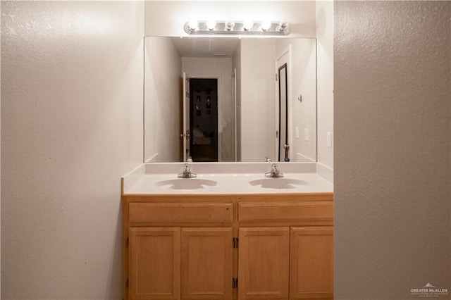2401 Wisteria Ave, Mcallen, TX 78504 - bathroom with double vanity and a textured wall