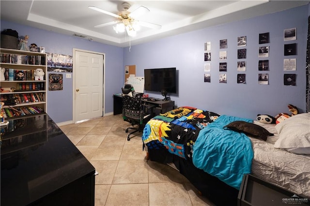 2401 Wisteria Ave, Mcallen, TX 78504 - bedroom featuring a tray ceiling, light tile patterned floors, and a ceiling fan