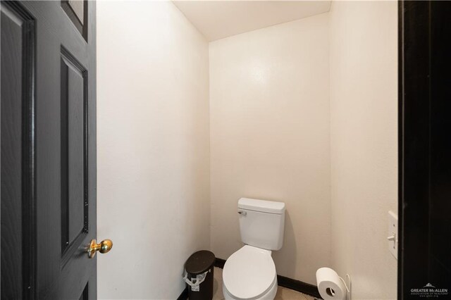 2401 Wisteria Ave, Mcallen, TX 78504 - bathroom with toilet and baseboards
