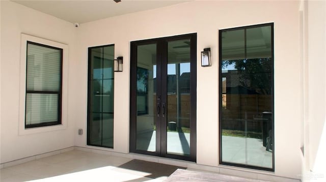 view of exterior entry with a patio area