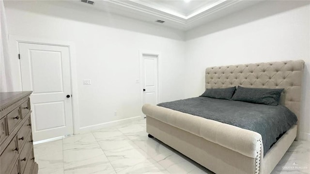 bedroom featuring a tray ceiling and ornamental molding