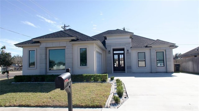 view of front of house with a front yard and french doors