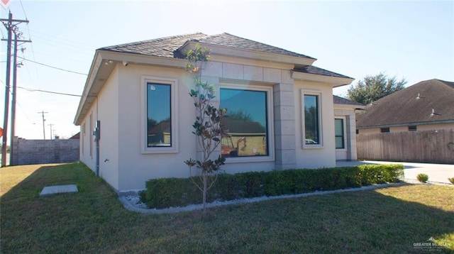 view of side of home featuring a lawn