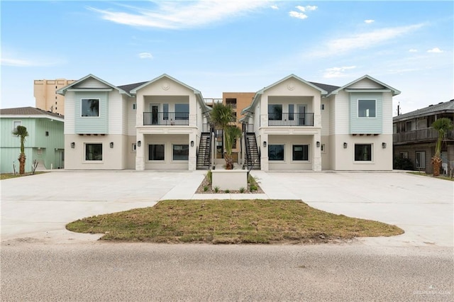 view of front of property featuring a garage and a balcony