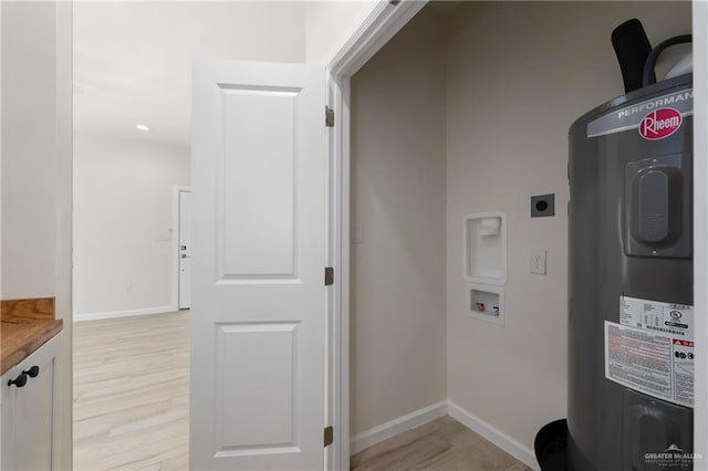 washroom featuring hookup for a washing machine, electric dryer hookup, electric water heater, and light wood-type flooring