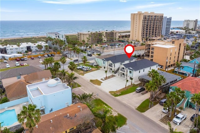 drone / aerial view featuring a view of the beach and a water view