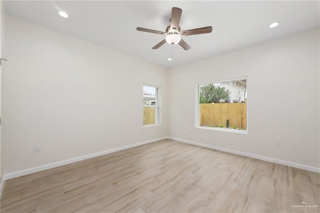 unfurnished room with ceiling fan and light wood-type flooring