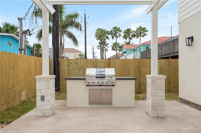 view of patio with area for grilling and exterior kitchen