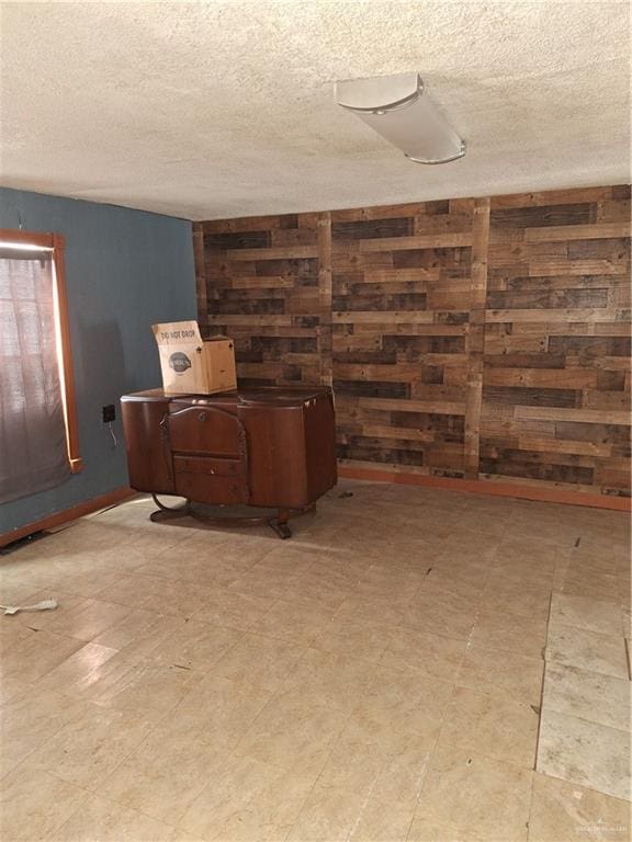 2044 Balboa Ave, Mcallen, TX 78503 - below grade area featuring a textured ceiling, wooden walls, and light flooring