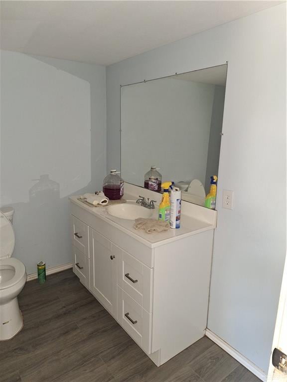 2044 Balboa Ave, Mcallen, TX 78503 - bathroom with vanity, toilet, and wood finished floors