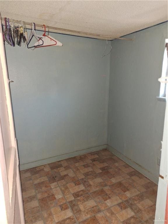 2044 Balboa Ave, Mcallen, TX 78503 - unfurnished room featuring brick patterned flooring, baseboards, and a textured ceiling