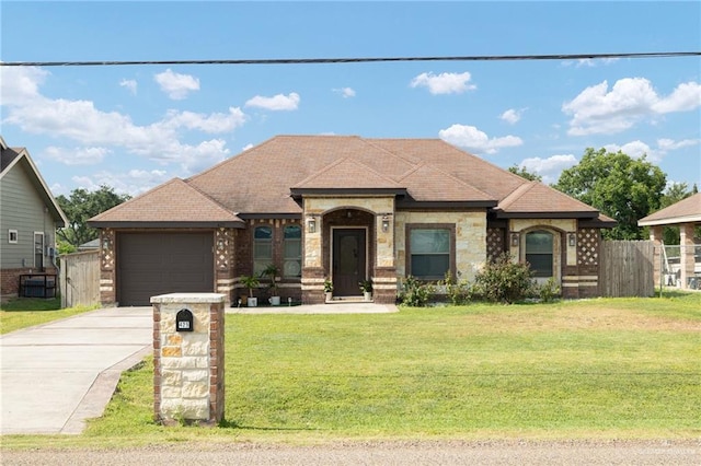 425 E Nebraska Rd, Alamo, TX 78516 - french country home with concrete driveway, a garage, and brick siding