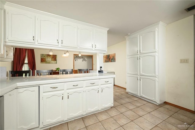 26086 Rabb Rd, La Feria, TX 78559 - kitchen featuring white cabinetry, light tile patterned flooring, light countertops, baseboards, and a peninsula
