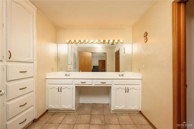 26086 Rabb Rd, La Feria, TX 78559 - bathroom with double vanity, tile patterned floors, and baseboards