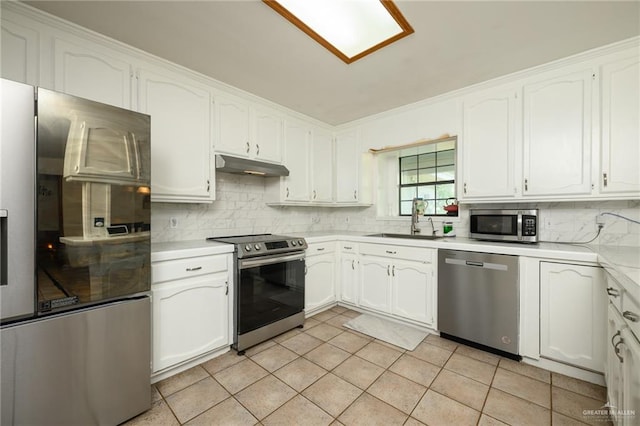26086 Rabb Rd, La Feria, TX 78559 - kitchen featuring stainless steel appliances, a sink, light countertops, decorative backsplash, and white cabinetry