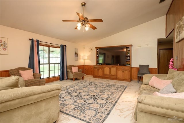 26086 Rabb Rd, La Feria, TX 78559 - living area with ceiling fan, vaulted ceiling, a wainscoted wall, light marble finish flooring, and wood walls