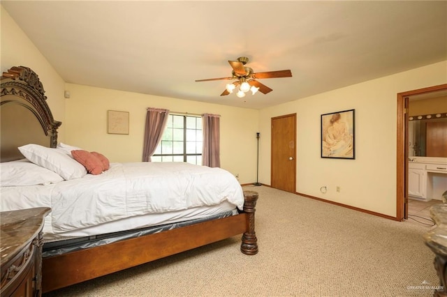 26086 Rabb Rd, La Feria, TX 78559 - bedroom featuring light colored carpet, baseboards, ensuite bath, and a ceiling fan