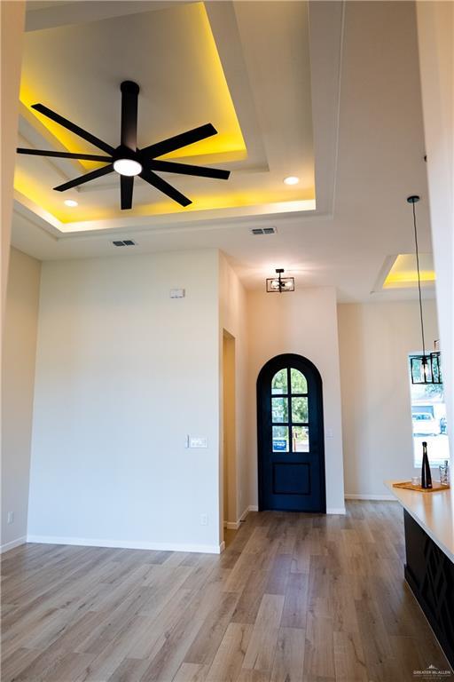 800 W Ruisenor Ave, Pharr, TX 78577 - foyer entrance featuring a tray ceiling, light wood-style floors, ceiling fan, and recessed lighting