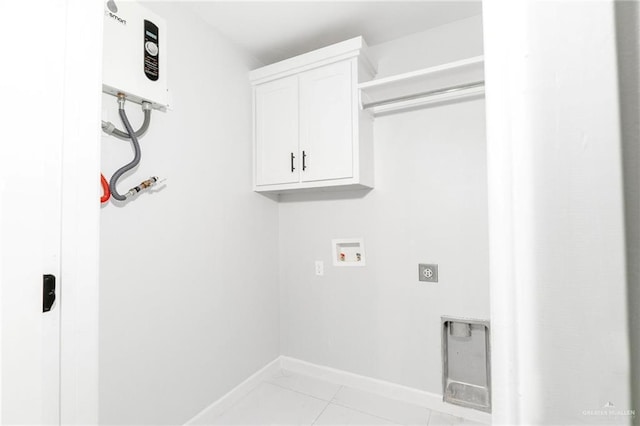 laundry area with washer hookup, cabinets, and light tile patterned floors