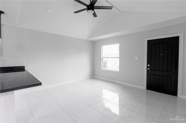 unfurnished living room with ceiling fan and vaulted ceiling