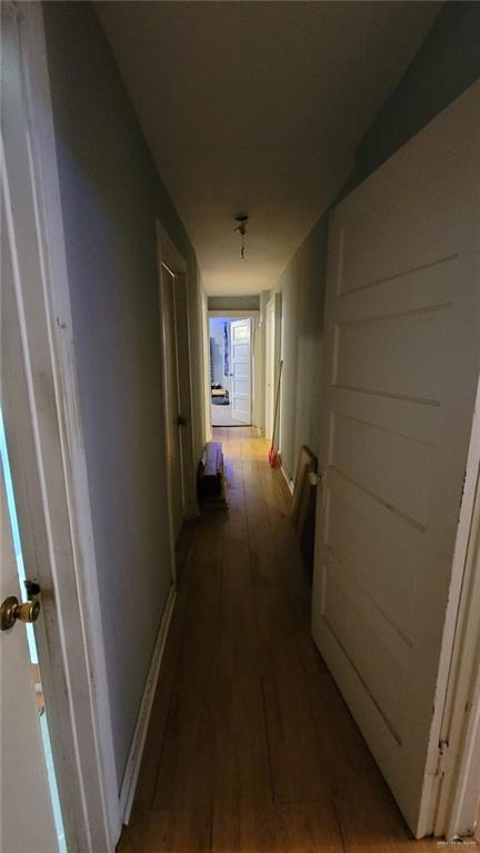 hallway with dark wood-type flooring