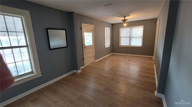 spare room featuring wood-type flooring