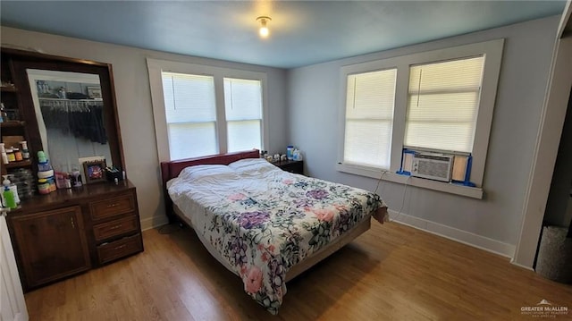 bedroom featuring cooling unit and light wood-type flooring