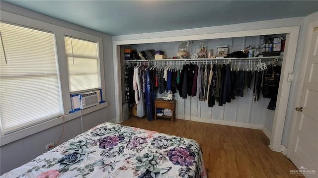 bedroom featuring hardwood / wood-style flooring, a closet, and cooling unit