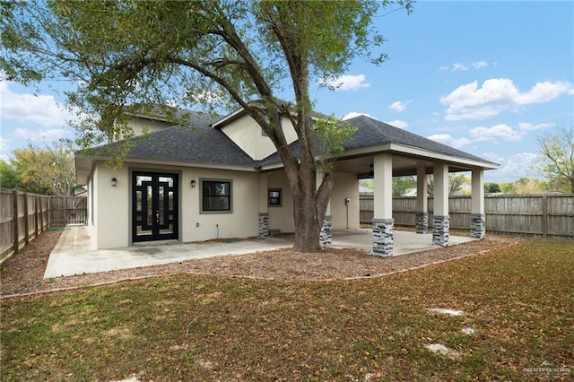 rear view of property featuring a patio and french doors