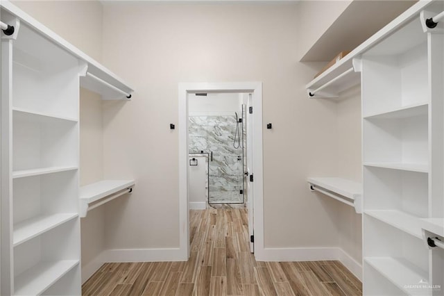 spacious closet with light hardwood / wood-style flooring