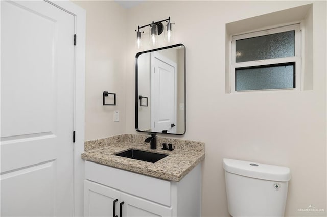 bathroom with vanity and toilet